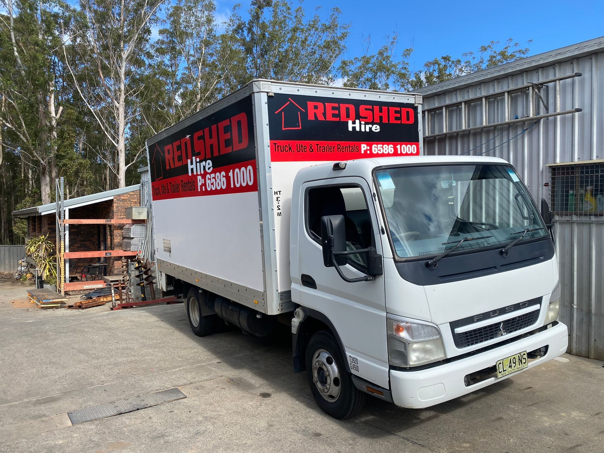 A White Truck Is Parked In Front Of A Building — Red Shed Hire In Wauchope, NSW