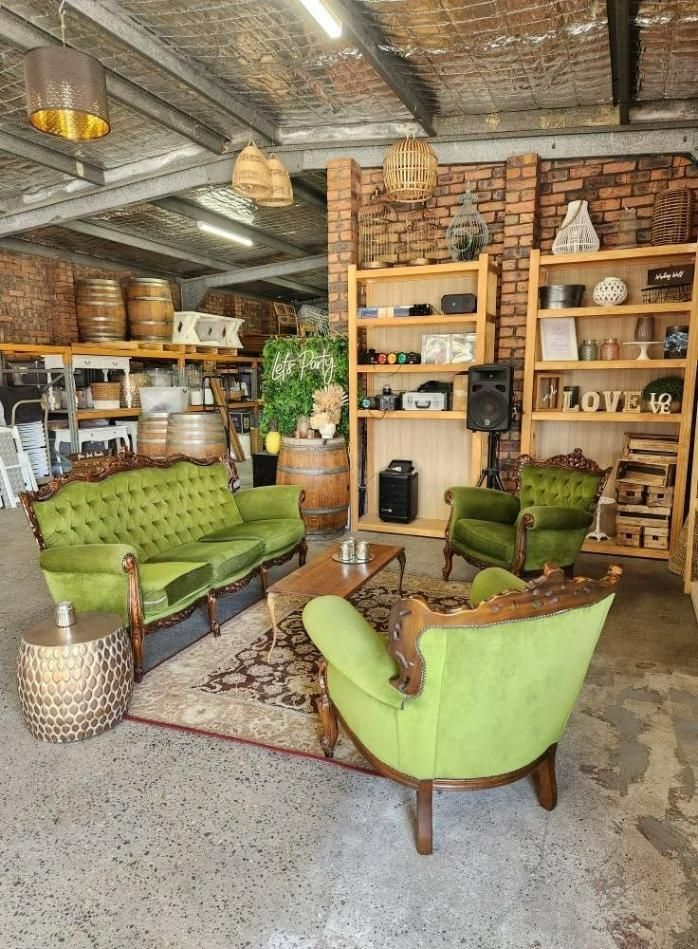 A Living Room With Green Furniture And A Brick Wall — Red Shed Hire In Wauchope, NSW