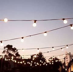 A String Of Lights Hanging From A Wire At Sunset — Red Shed Hire In Wauchope, NSW
