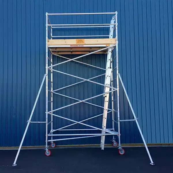 A Scaffolding With A Ladder Attached To It Is Sitting In Front Of A Blue Building — Red Shed Hire In Wauchope, NSW