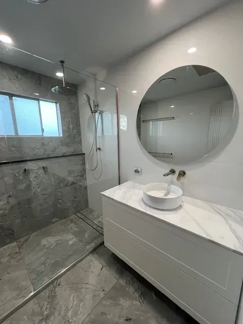 A Bathroom With a Sink, Mirror and Walk in Shower — Coastwide Plumbing Solutions in Buderim, QLD