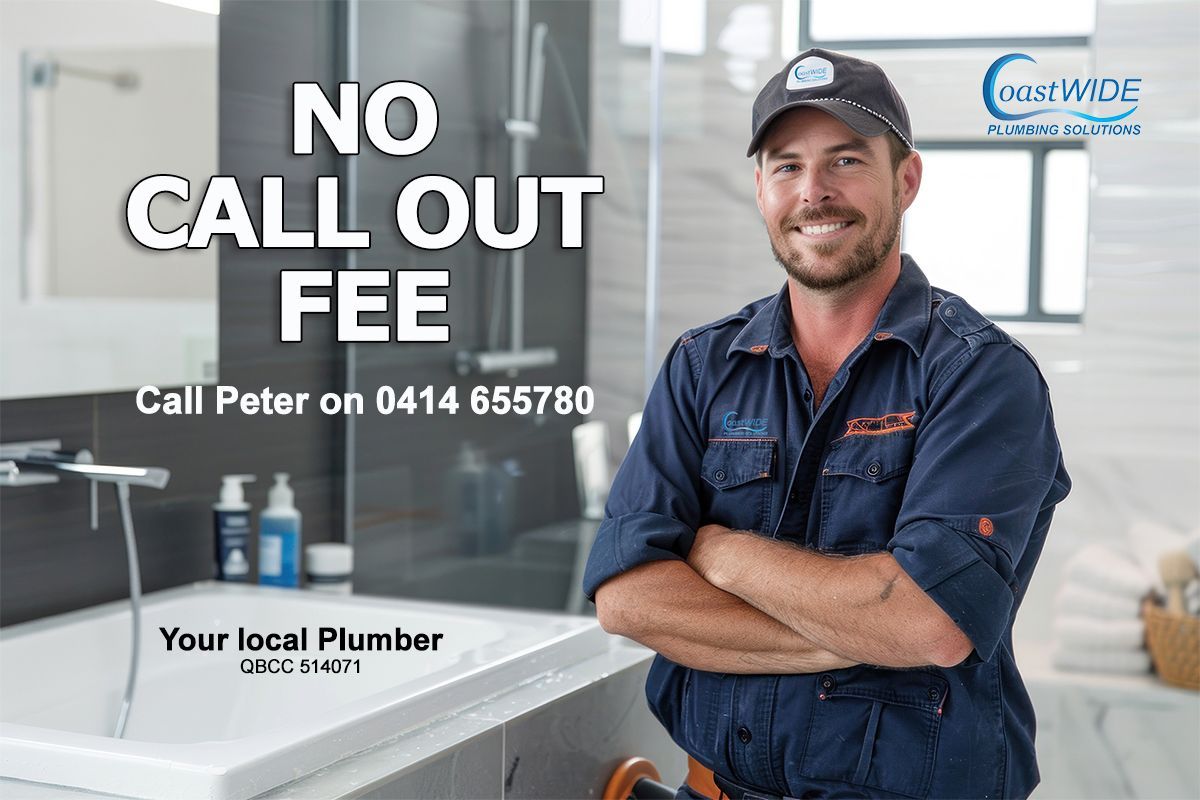 A Plumber is Standing in a Bathroom With His Arms Crossed — Coastwide Plumbing Solutions in Sippy Downs, QLD