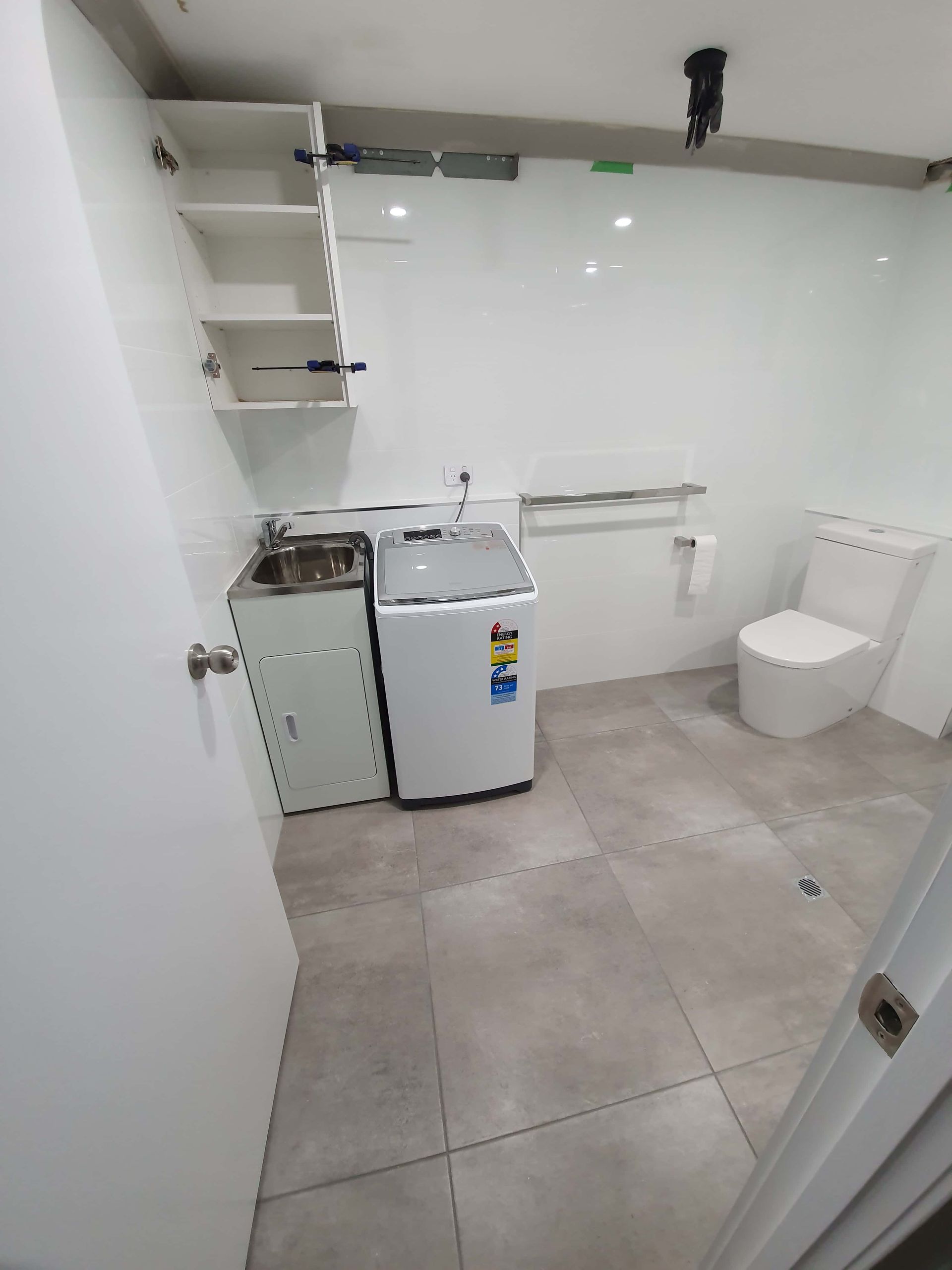 A Row of White Sinks Are Lined Up in a Bathroom — Coastwide Plumbing Solutions in Sippy Downs, QLD