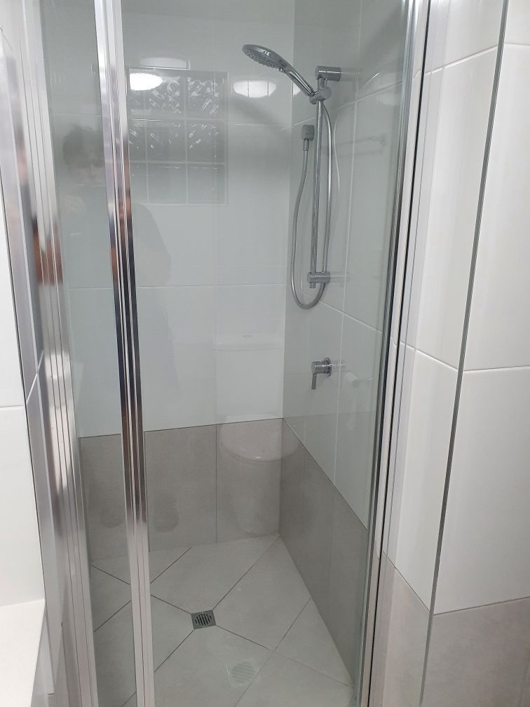 A Bathroom With a Walk in Shower and a Shower Head — Coastwide Plumbing Solutions in Sippy Downs, QLD