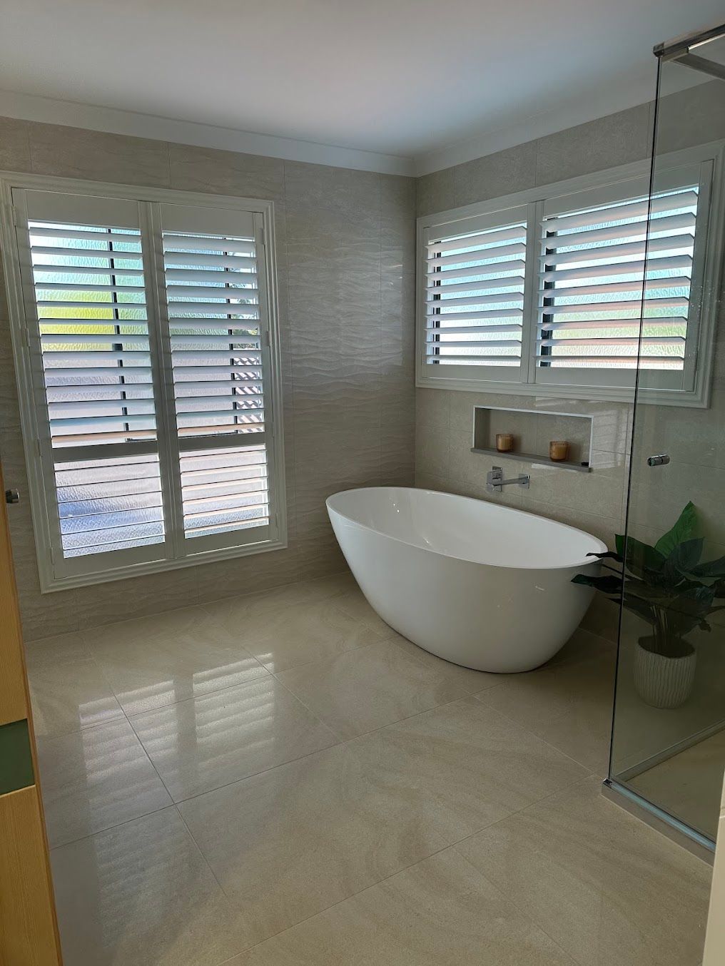 A Bathroom With a Bathtub and Shutters on the Windows — Coastwide Plumbing Solutions in Sippy Downs, QLD