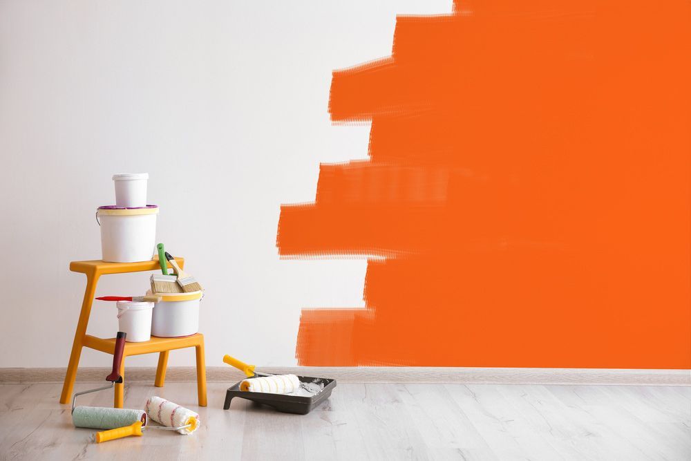 Set of Tools for Painting With Orange Paint Wall — Paint & Decor in Birdsville, QLD