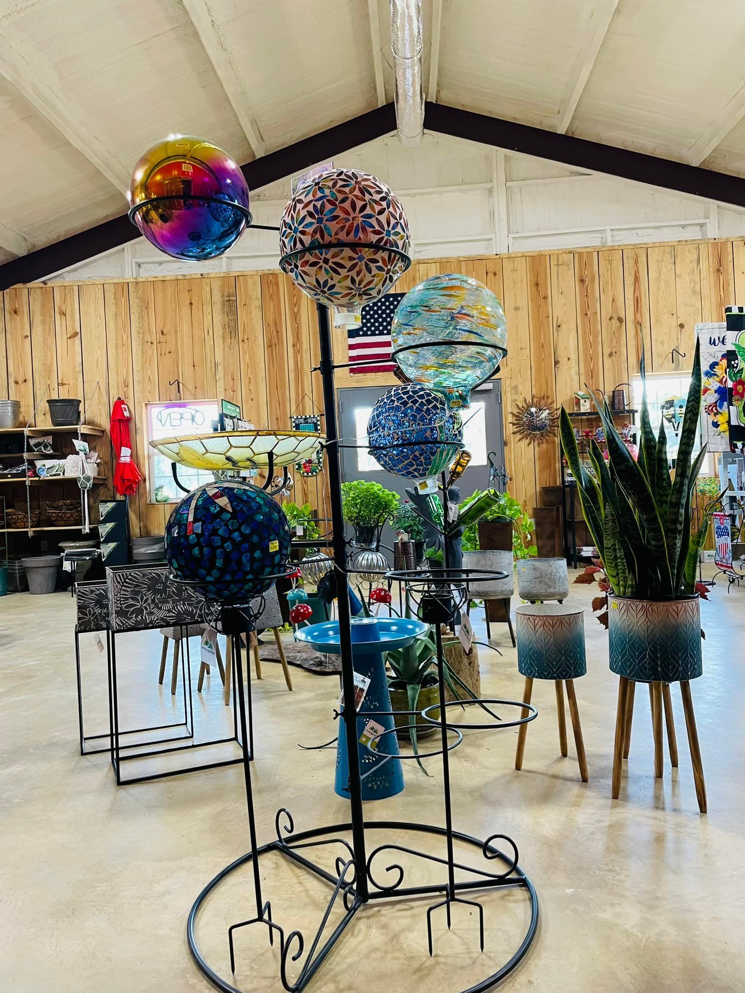Metal display stand with colorful decorative spheres in a store.