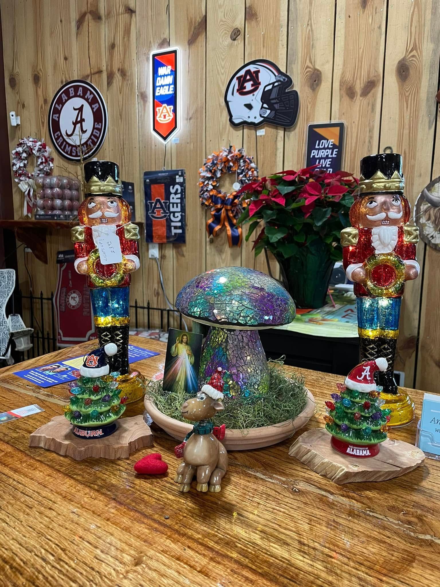 Holiday display with nutcrackers, Christmas trees, mushroom decor, and Auburn memorabilia.