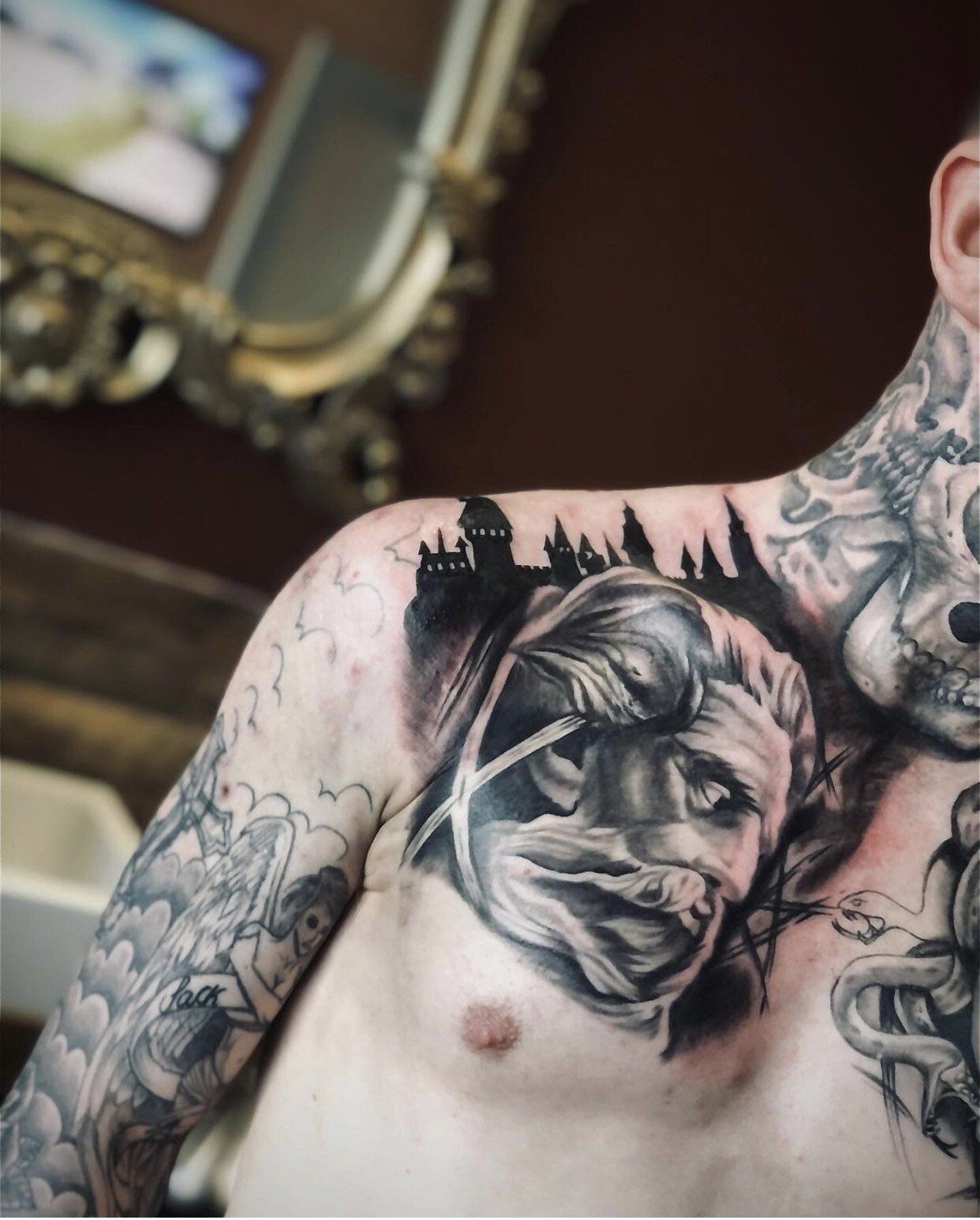 A man with a tattoo on his chest and shoulder