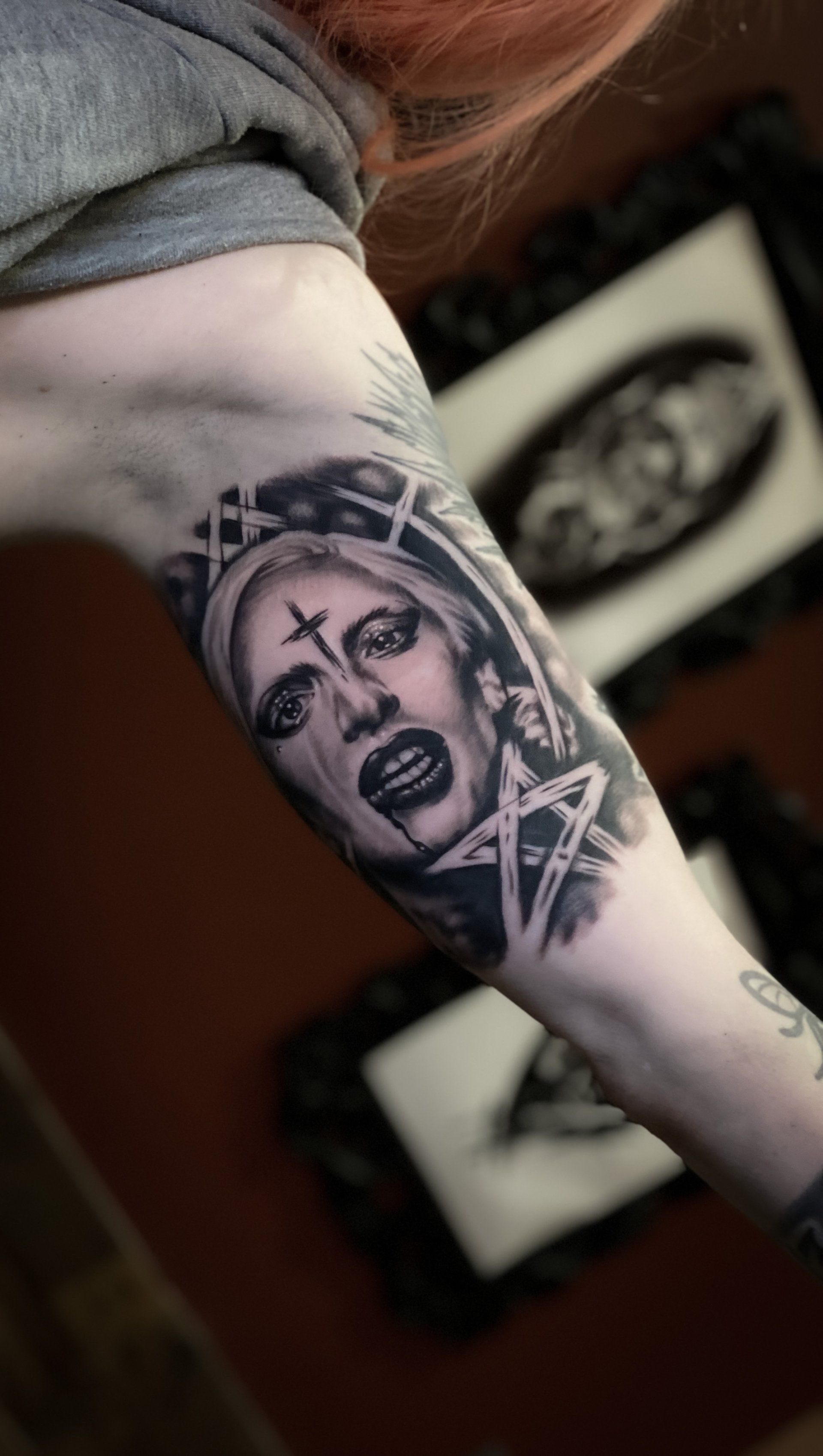 A woman has a tattoo of a nun on her arm.