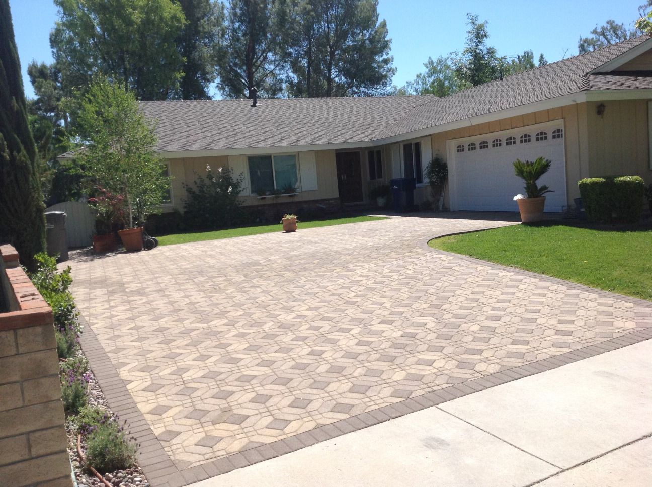 A driveway leading to a house with a white garage door