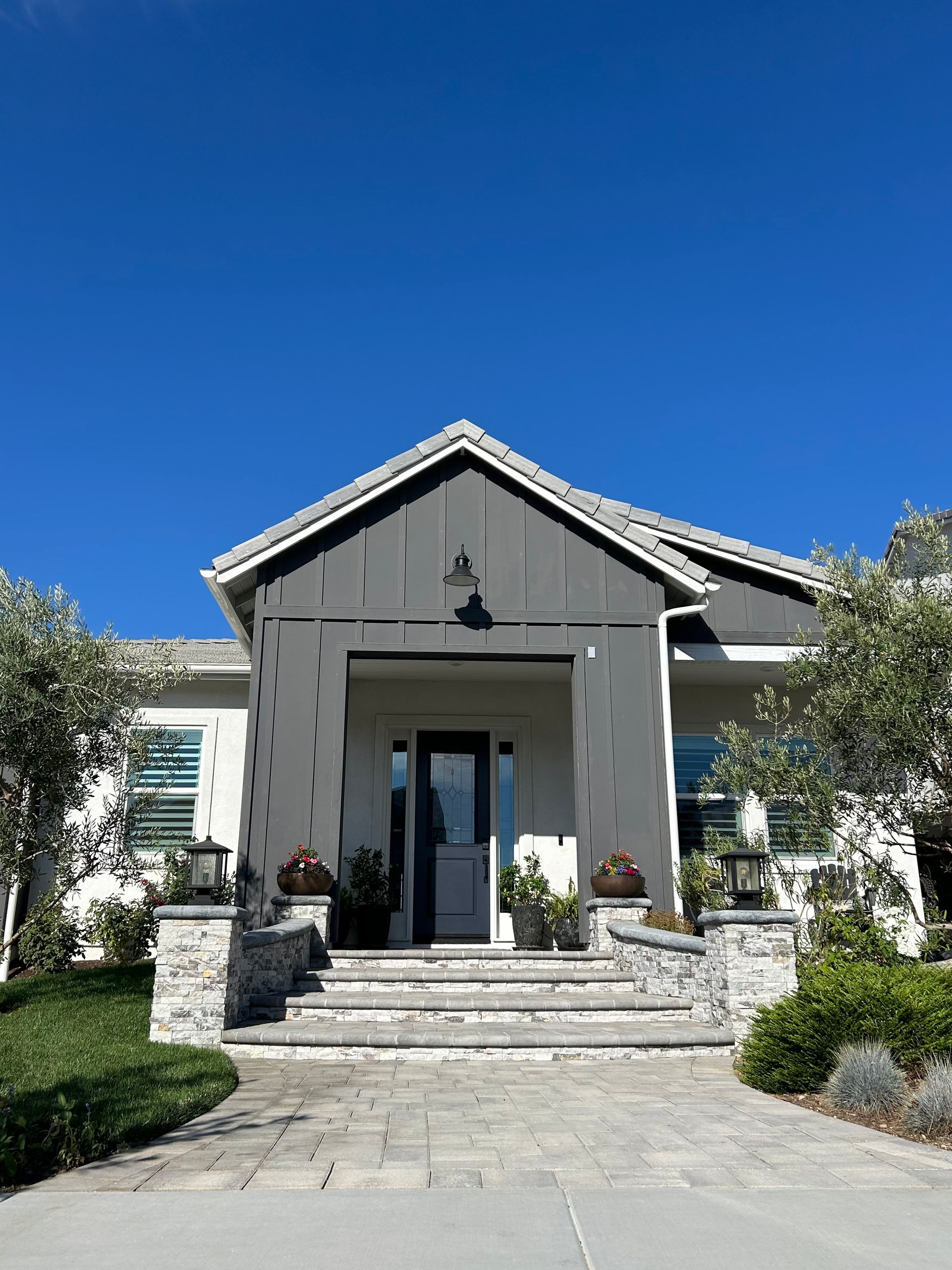 A large white house with a blue sky in the background.