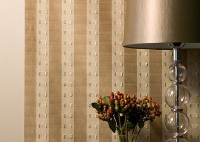 Striped beige wallpaper with a lamp and flowers.