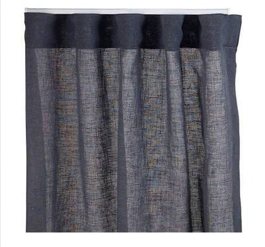 Dark blue sheer curtains hanging from a white rod, with vertical folds.