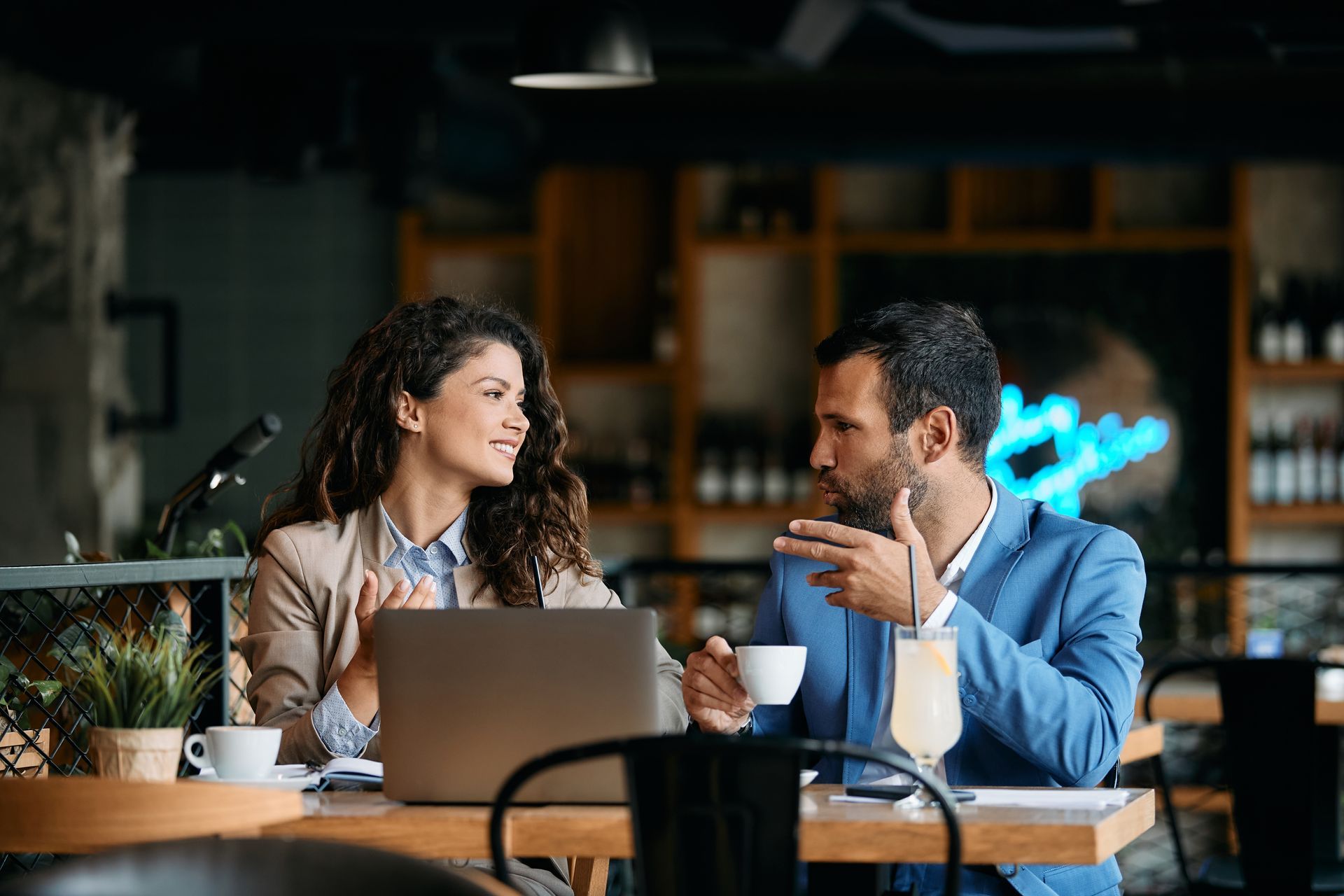 A man and a woman are looking at a clipboard.