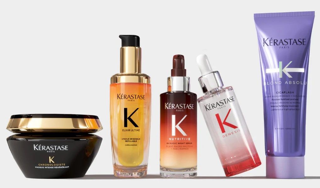 Kerastase hair care products in various bottles and jars; gold, orange, and purple hues.
