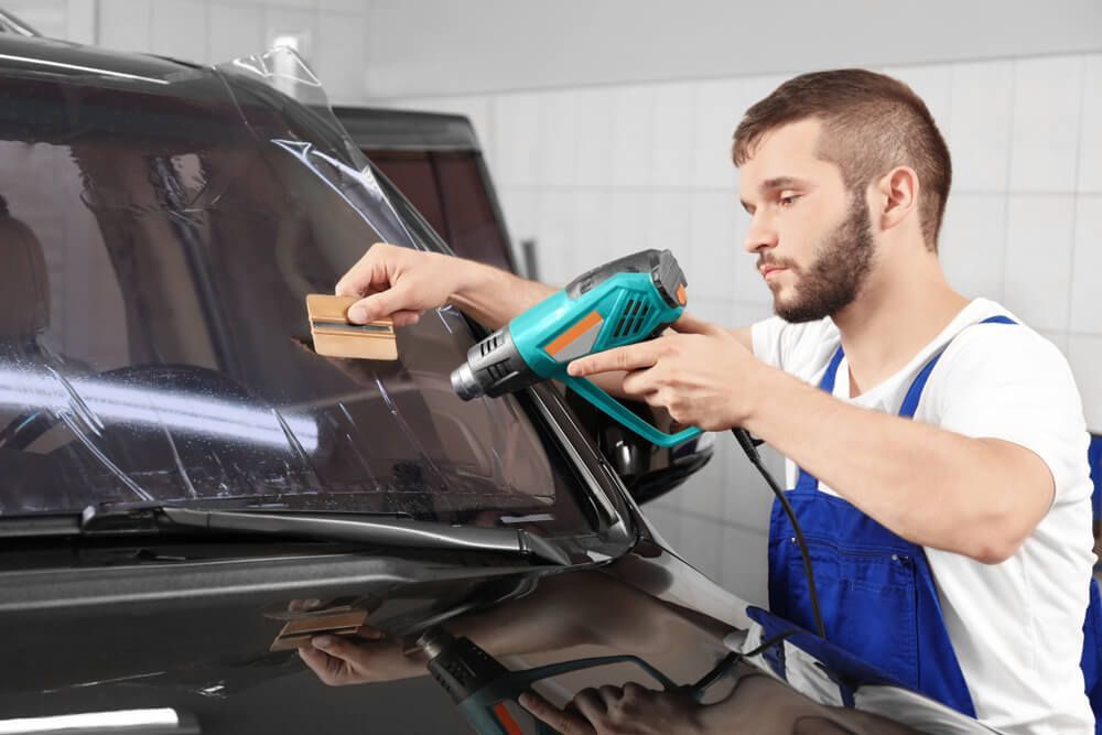 Worker Tinting Car Windscreen in Shop— Shepparton Radiators & Windscreens in Shepparton, VIC
