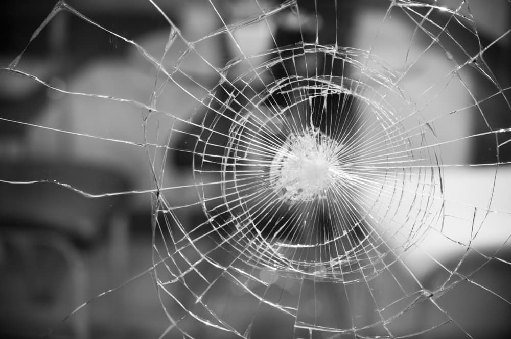 A Black and White Photo of a Broken Glass Window — Shepparton Radiators & Windscreens in Shepparton, VIC