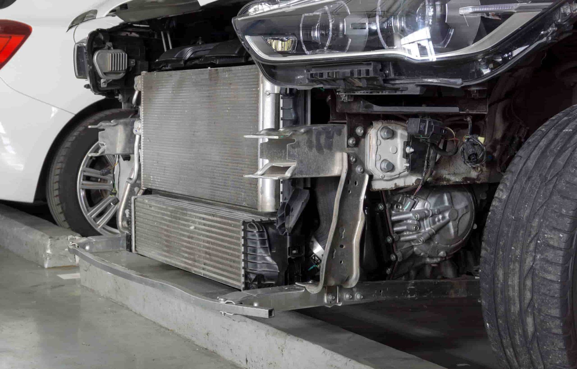 The Front End of a Car is Being Removed in a Garage — Shepparton Radiators & Windscreens in Echuca, VIC
