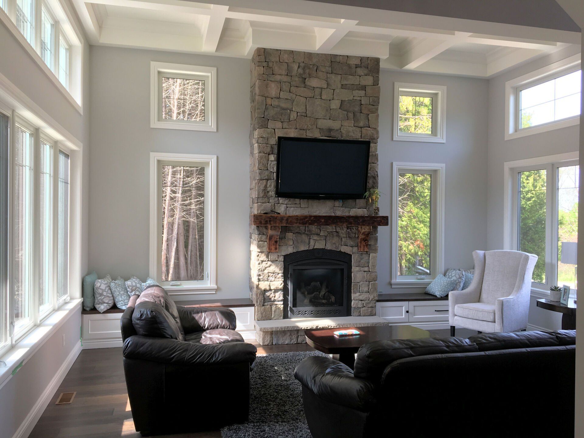A living room with a fireplace and a flat screen tv.