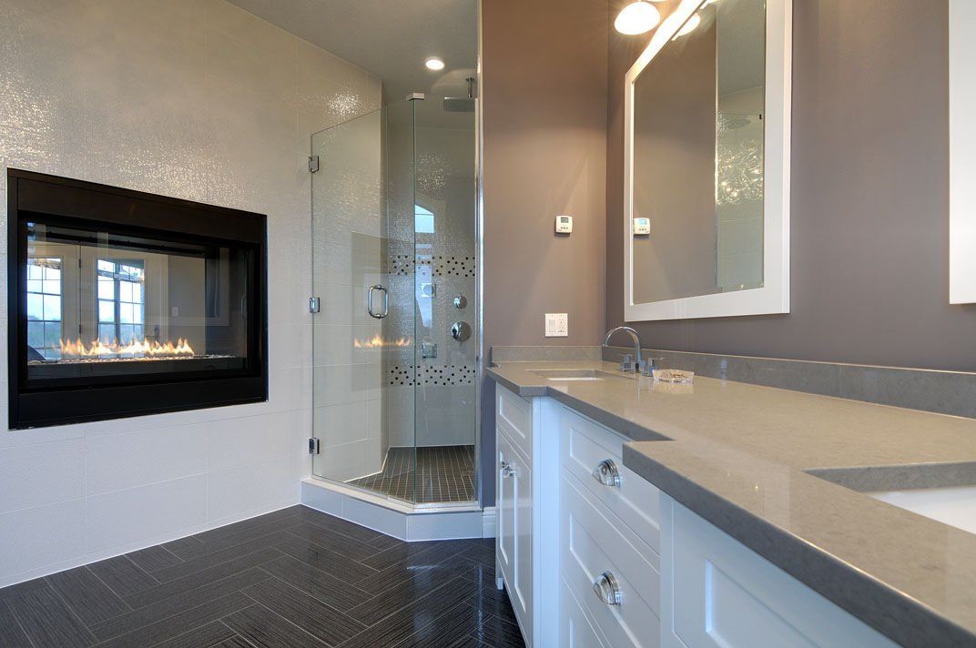 A bathroom with a fireplace and a walk in shower.