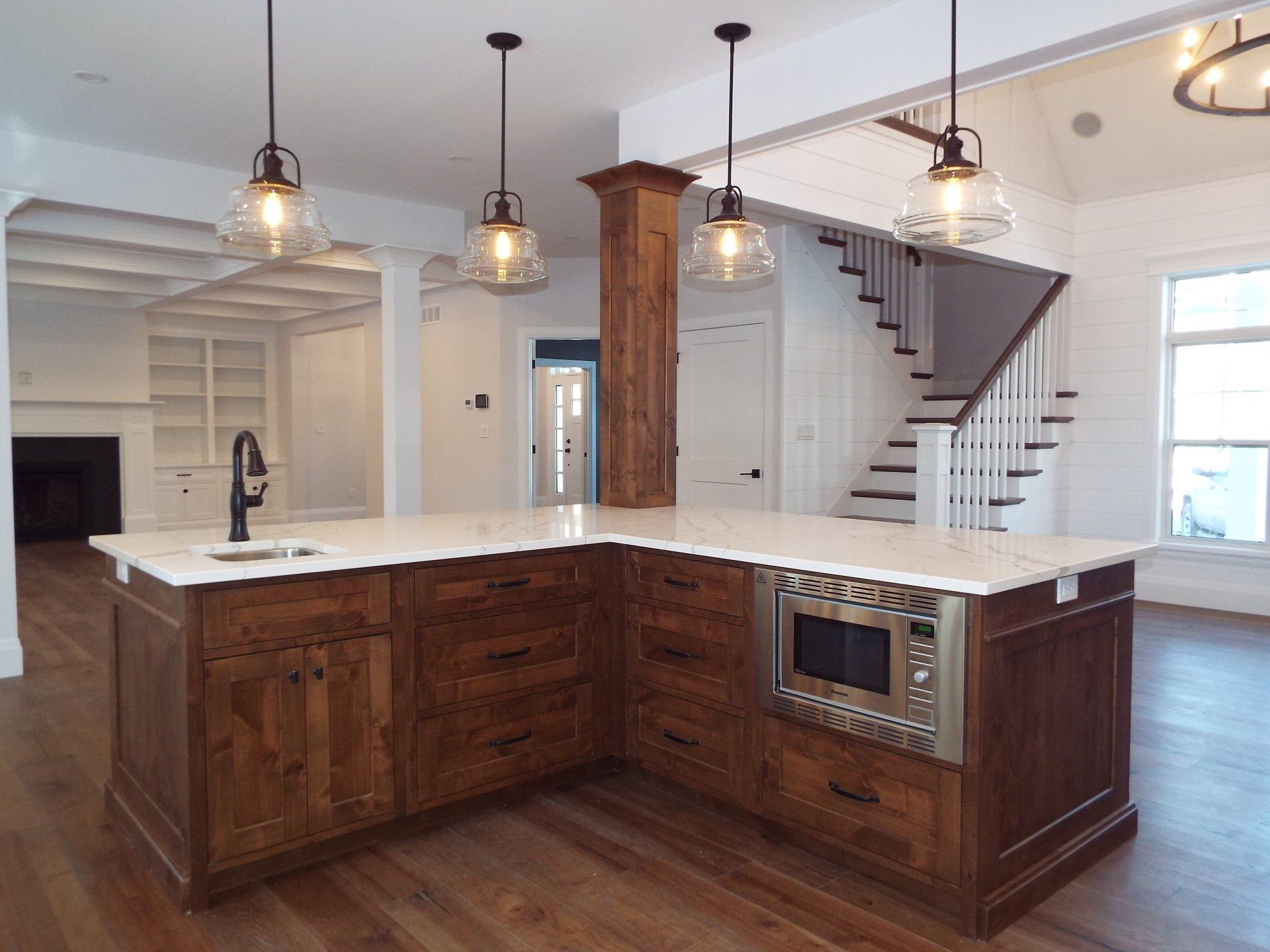 A kitchen with a large island and a microwave oven