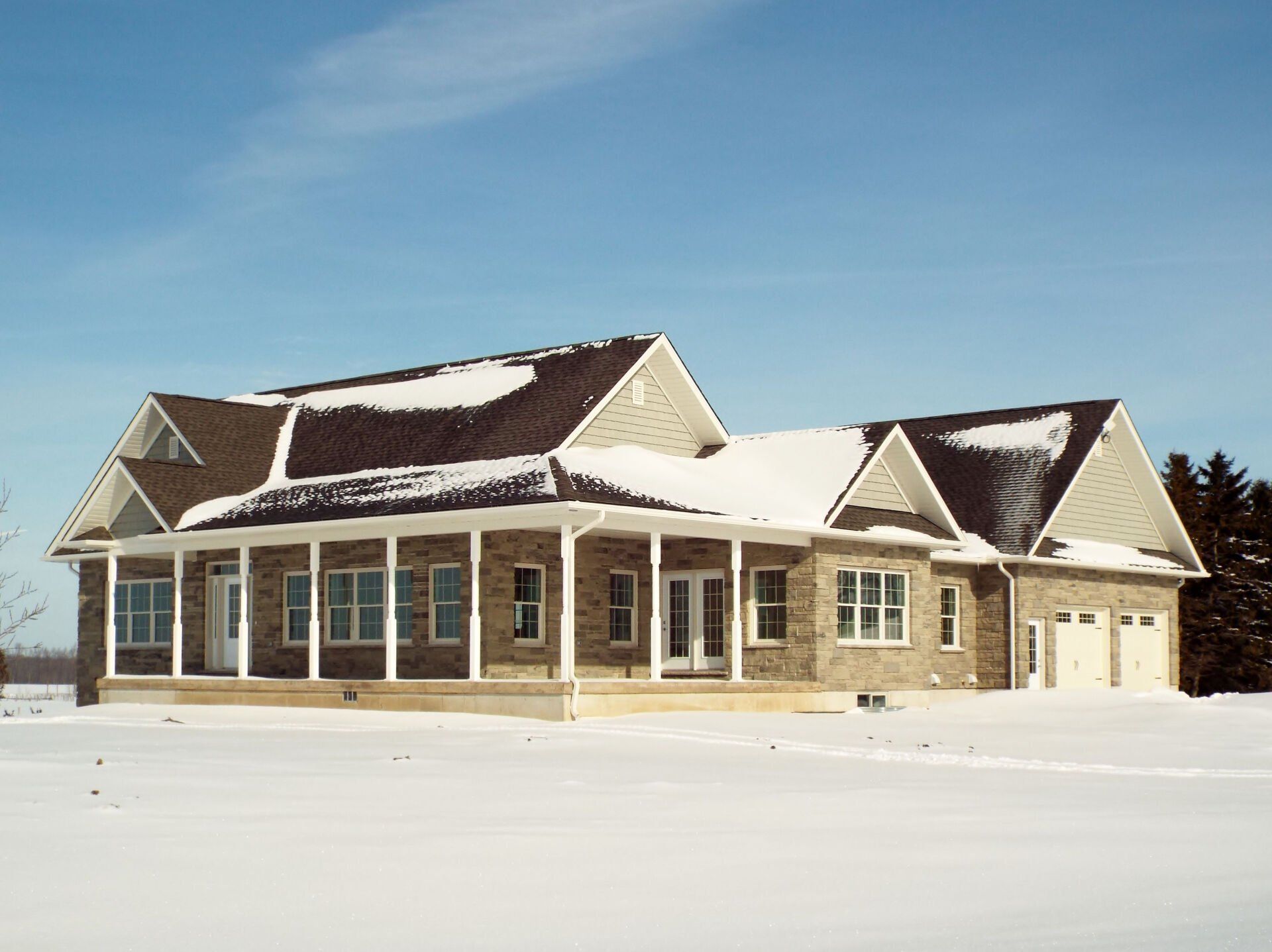 A large house in the middle of a snowy field