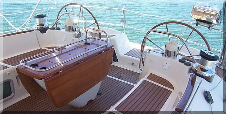 A boat with a wooden table and steering wheel in the water