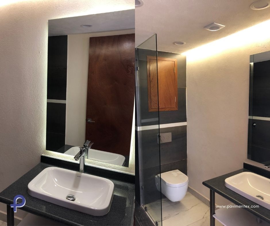 Un baño con lavabo, inodoro y espejo.