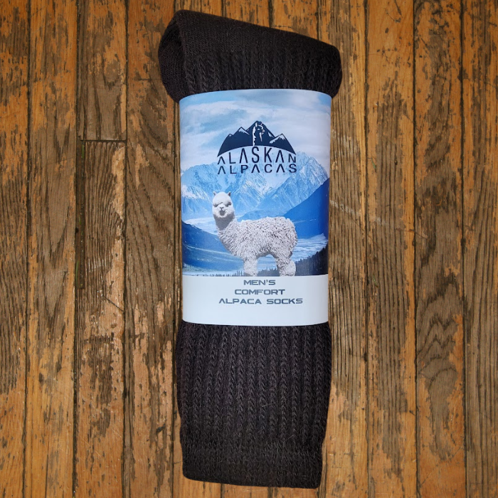 Brown alpaca wool socks with label: Alaskan Alpaca, a white alpaca, mountains, and sky.
