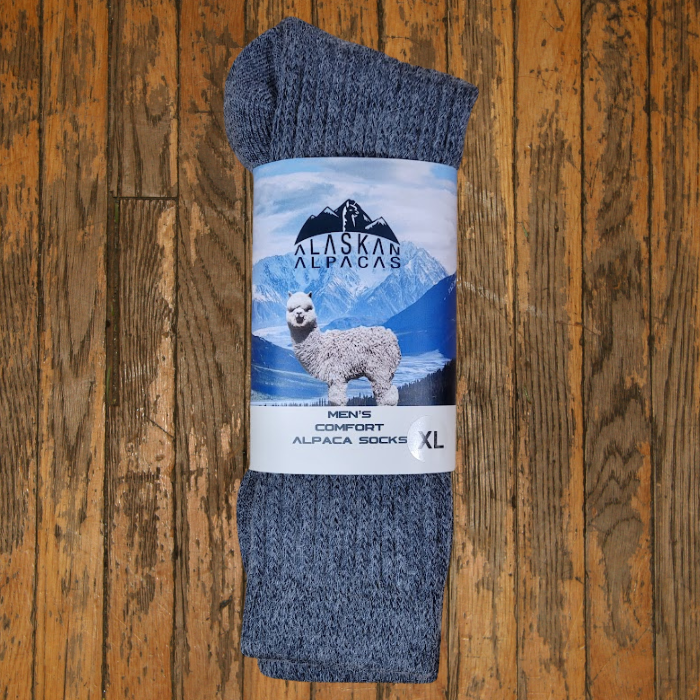 Pair of gray Alaskan Alpaca socks with band; illustration of alpaca and mountains.