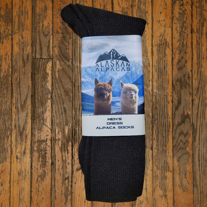 Dark brown alpaca socks with label featuring alpacas and a mountain range.