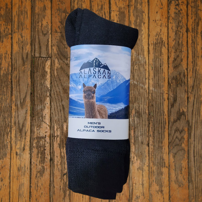 Black alpaca socks with a label showing an alpaca and mountains.