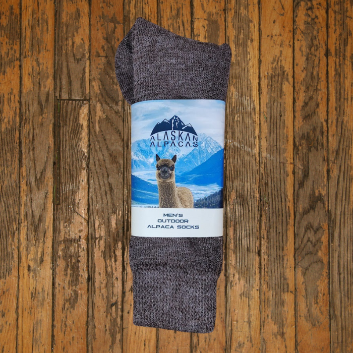 Brown alpaca socks with a label showing an alpaca, mountains, and the words
