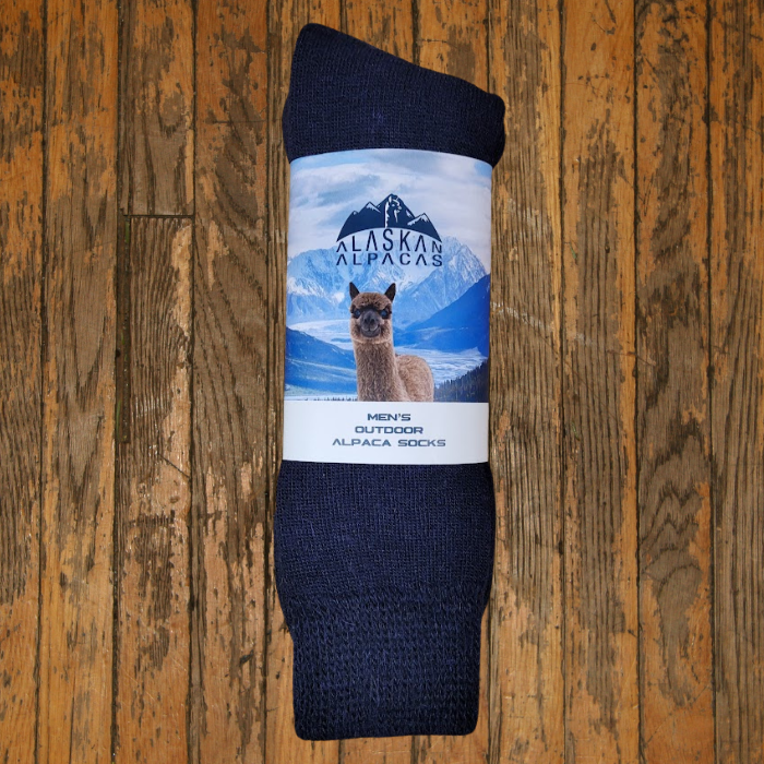 Dark blue alpaca socks with a label showing an alpaca and mountains.