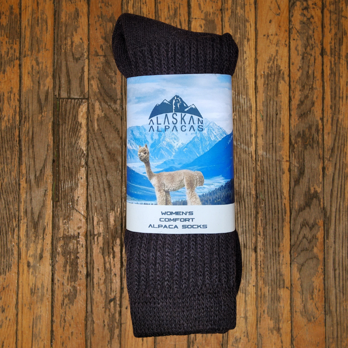 Brown alpaca socks with a label showing an alpaca and mountains.