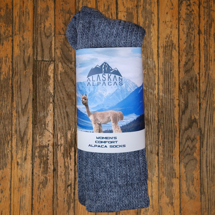 Gray alpaca wool socks with a label showing an alpaca and mountains.