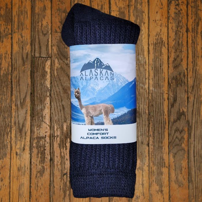 Dark blue rolled alpaca socks with a label showing an alpaca and mountains.