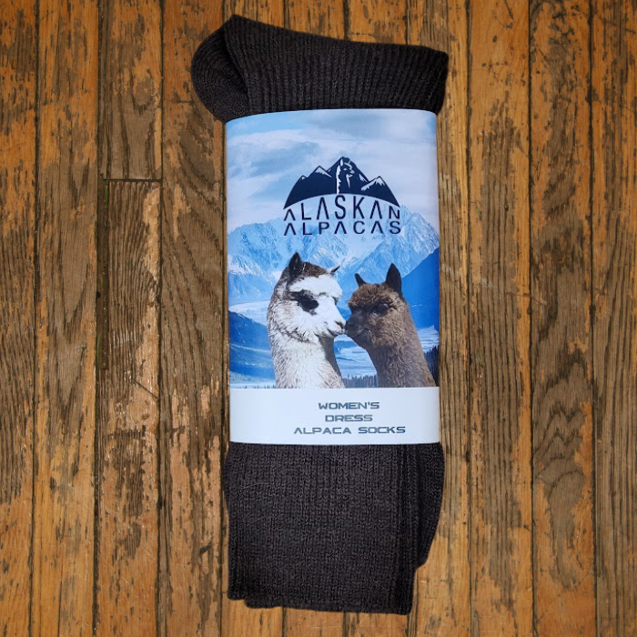Dark brown alpaca socks with a label featuring two alpacas and Alaskan Alpaca logo.