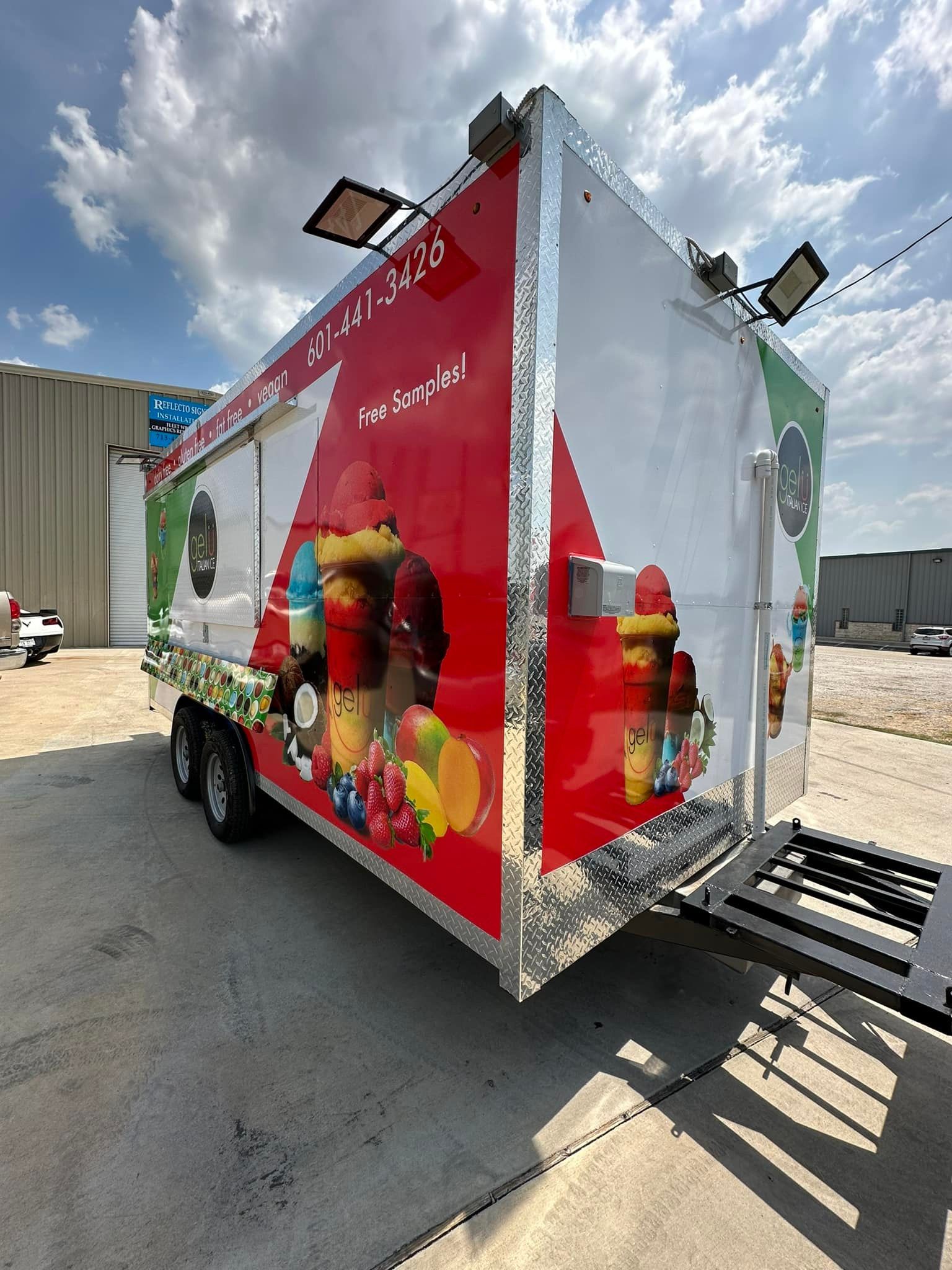A line of parked vans with red and blue 