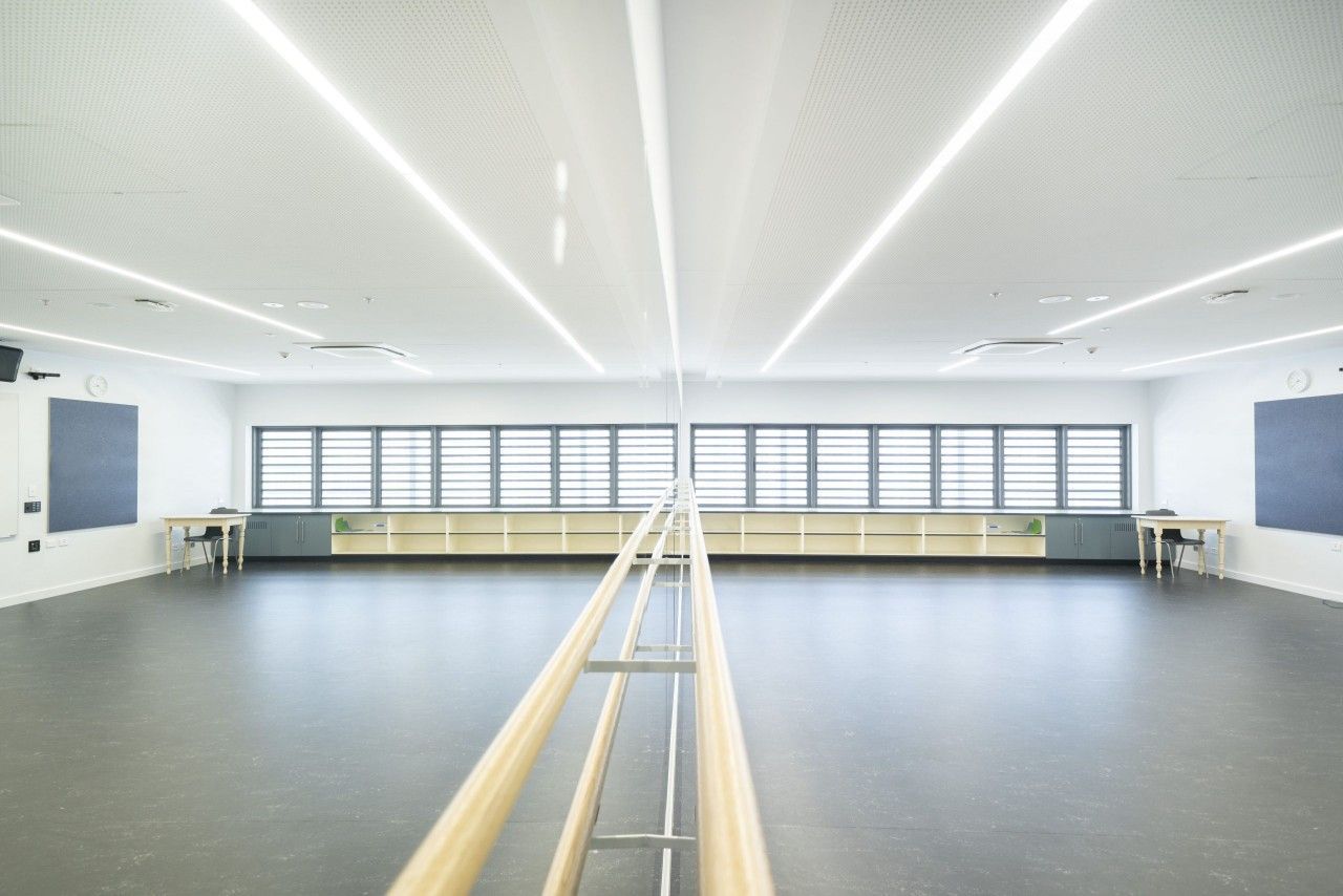 A Large Empty Dance Studio With a Wooden Ballet Barre — Nick Favot Painting in Bohle, QLD