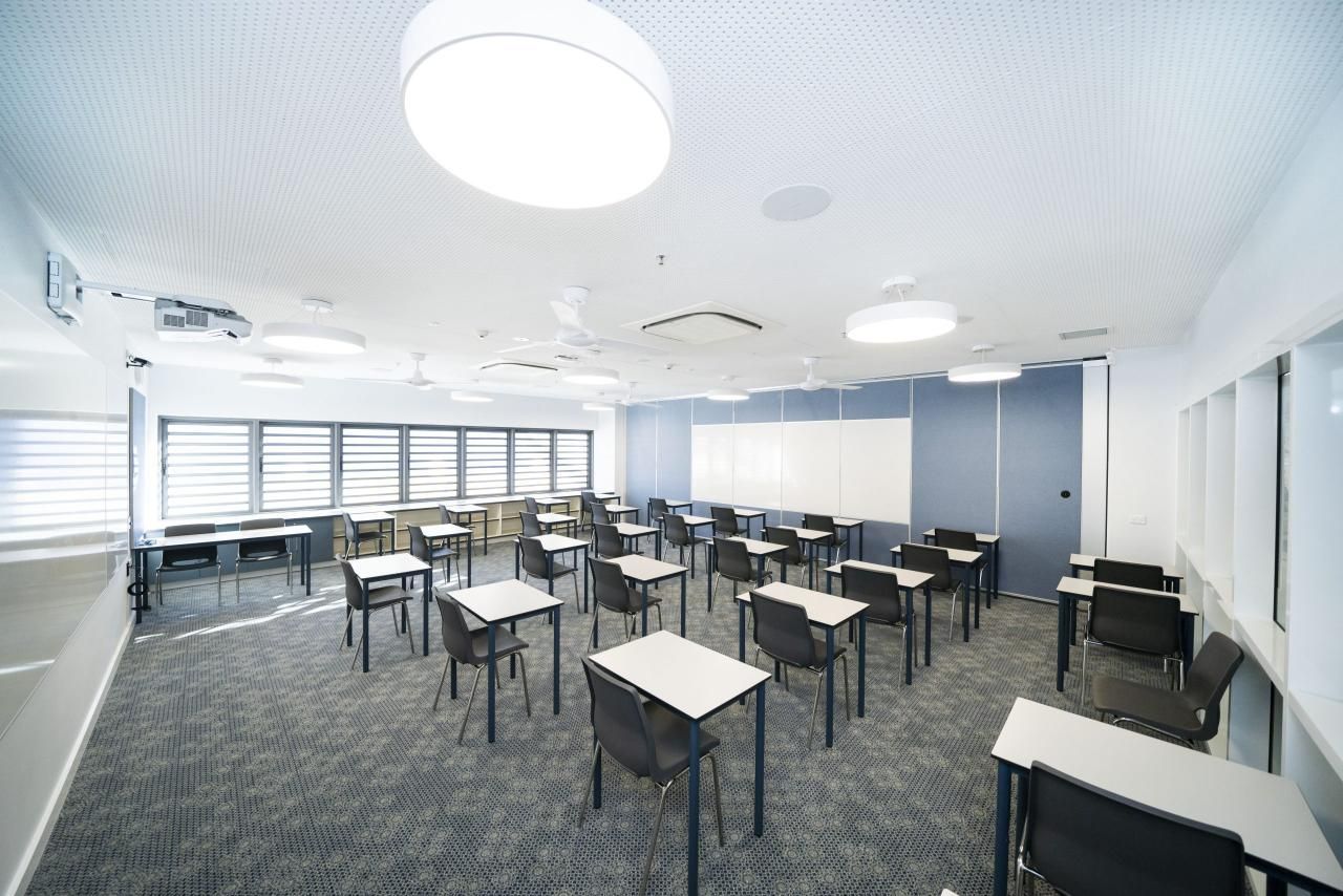 A Large Classroom With Tables and Chairs in It — Nick Favot Painting in Bohle, QLD