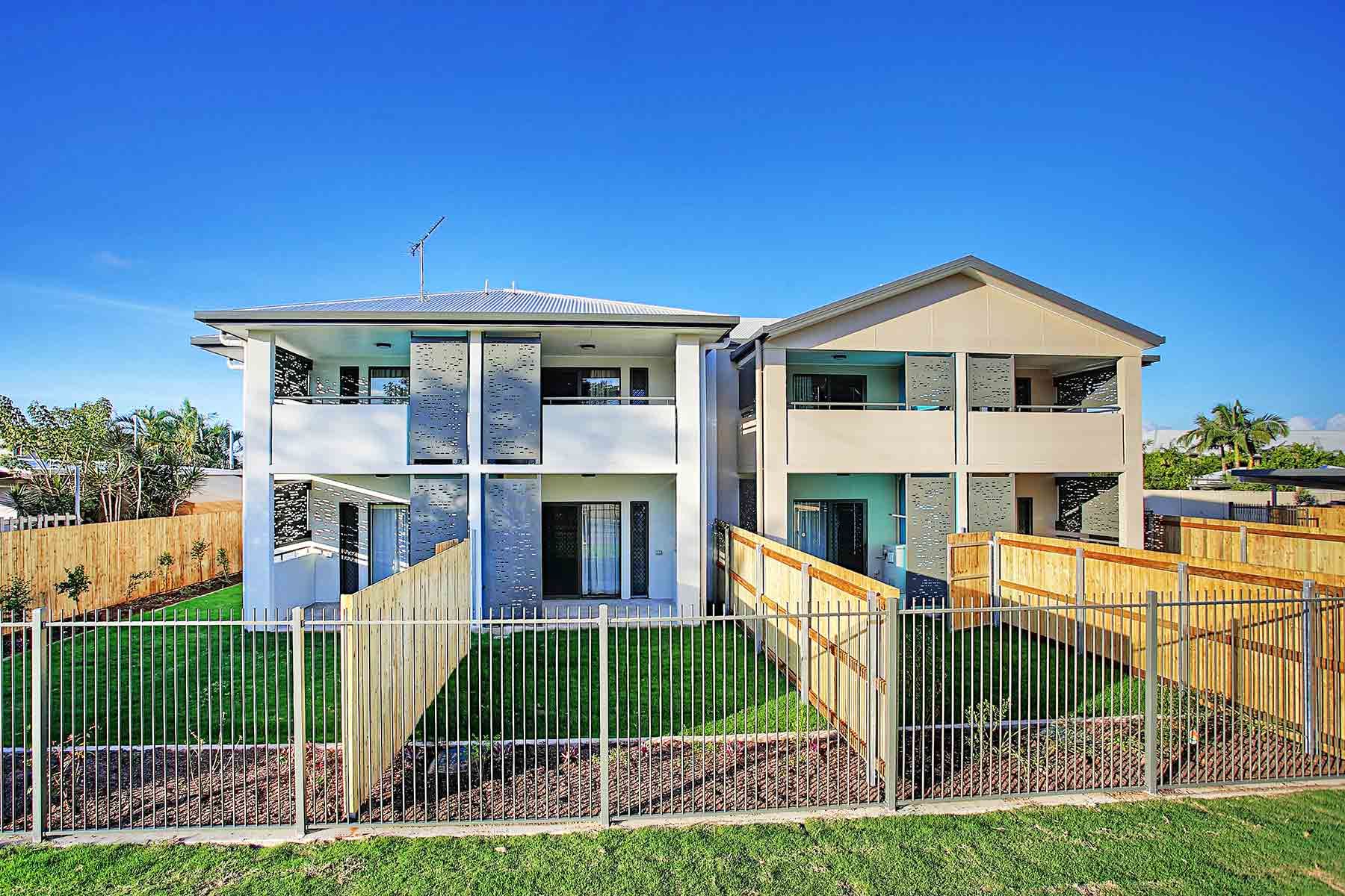 Two Modern Duplex Buildings With Wooden Fences — Nick Favot Painting In Bohle, QLD