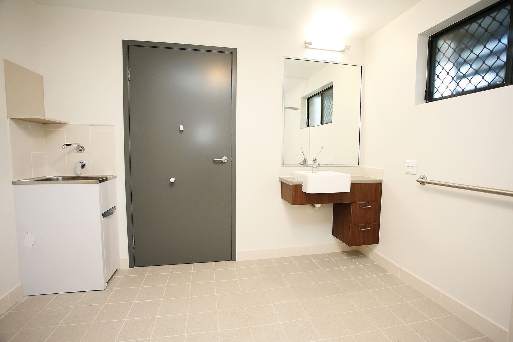 Bathroom With Light Beige Tiles and Dark Grey Door — Nick Favot Painting In Bohle, QLD