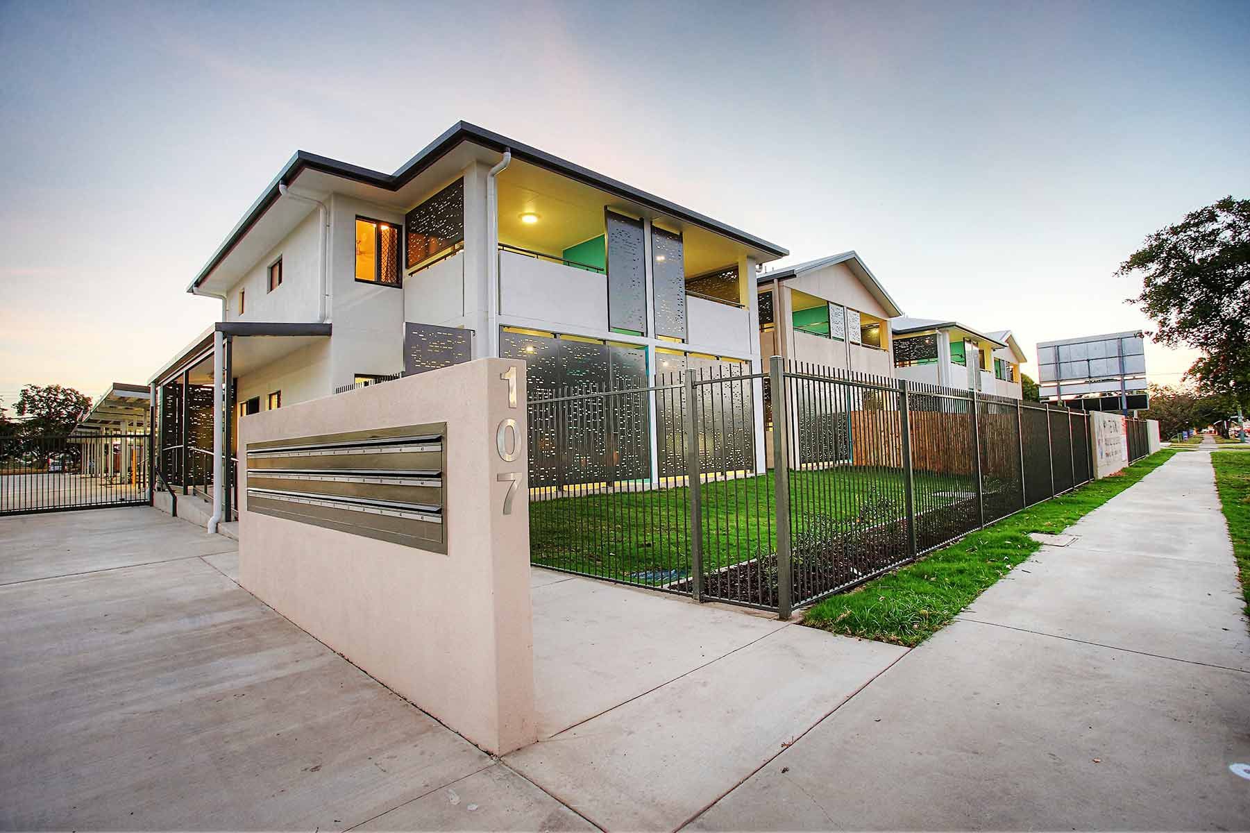 Two-storey Building With Large Windows and Decorative Panels — Nick Favot Painting In Bohle, QLD