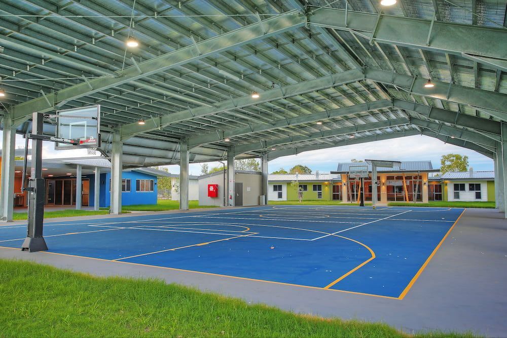 A Basketball Court Under a Covered Roof With a Basketball Hoop — Nick Favot Painting in Bohle, QLD