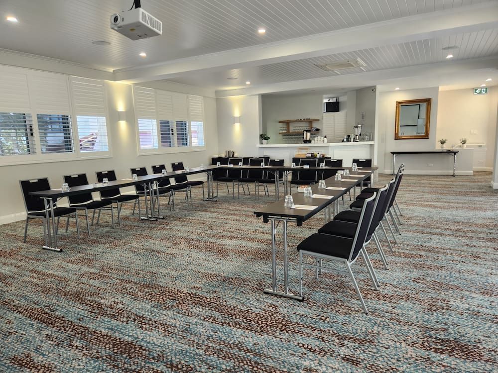 A Large Conference Room With Tables and Chairs and a Projector — Nick Favot Painting in Bohle, QLD
