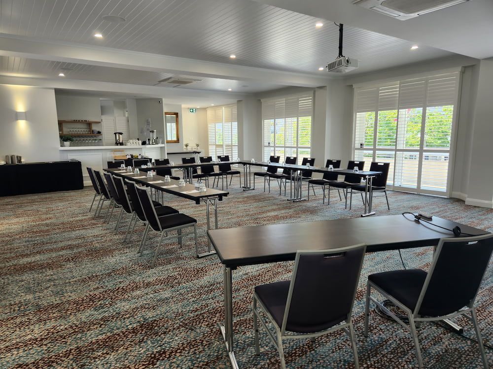 A Large Conference Room With Tables and Chairs and a Projector — Nick Favot Painting in Bohle, QLD