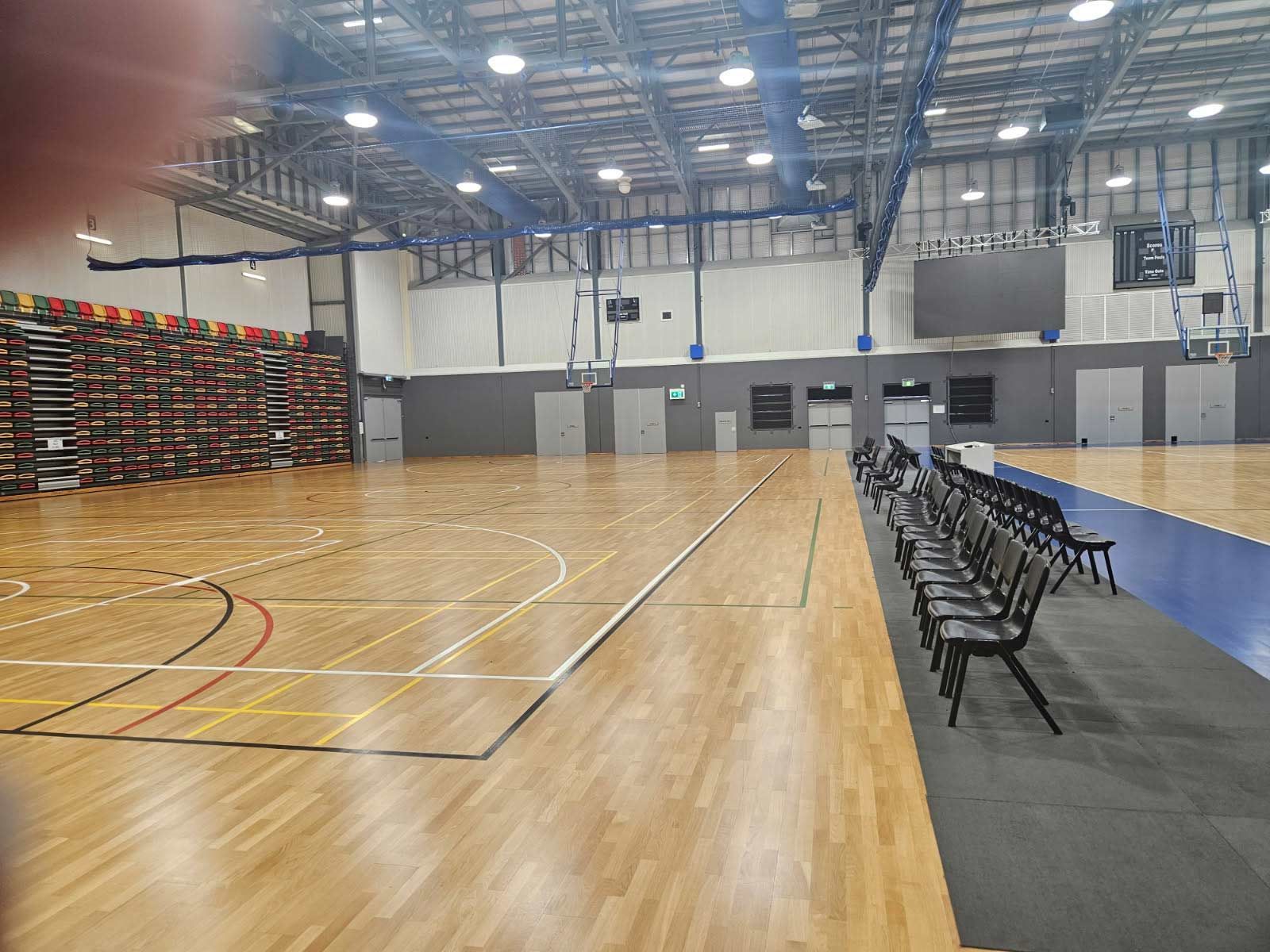 Indoor Basketball Court With Polished Wooden Floor — Nick Favot Painting In Bohle, QLD