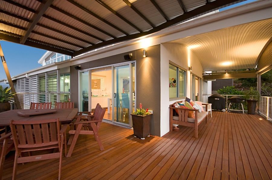 A Large Wooden Deck With a Table and Chairs on It — Nick Favot Painting in Bohle, QLD